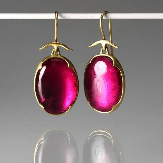 Earrings with pink crystals in old gold color