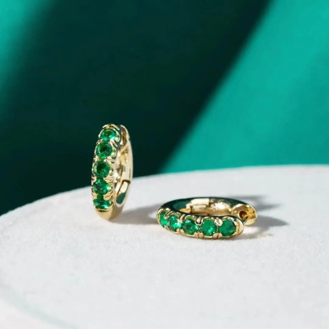 Gold earrings nuts with green zircons