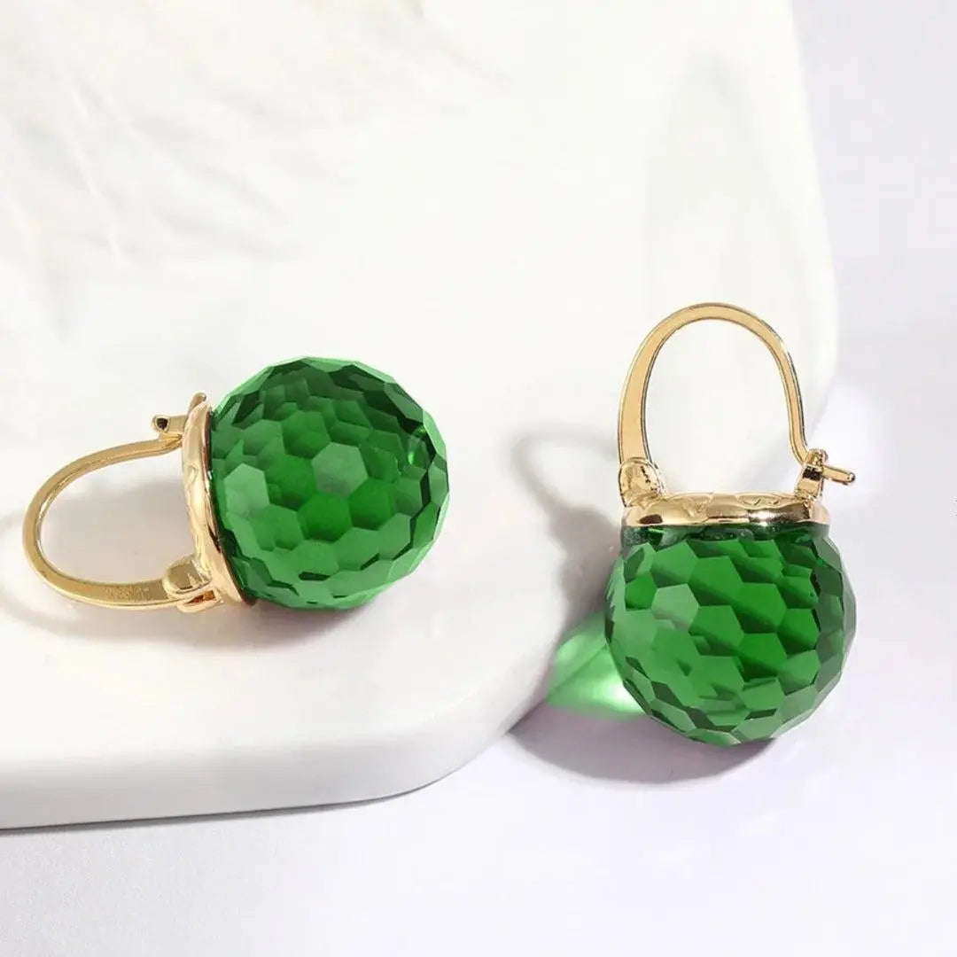 Gold earrings with green crystals