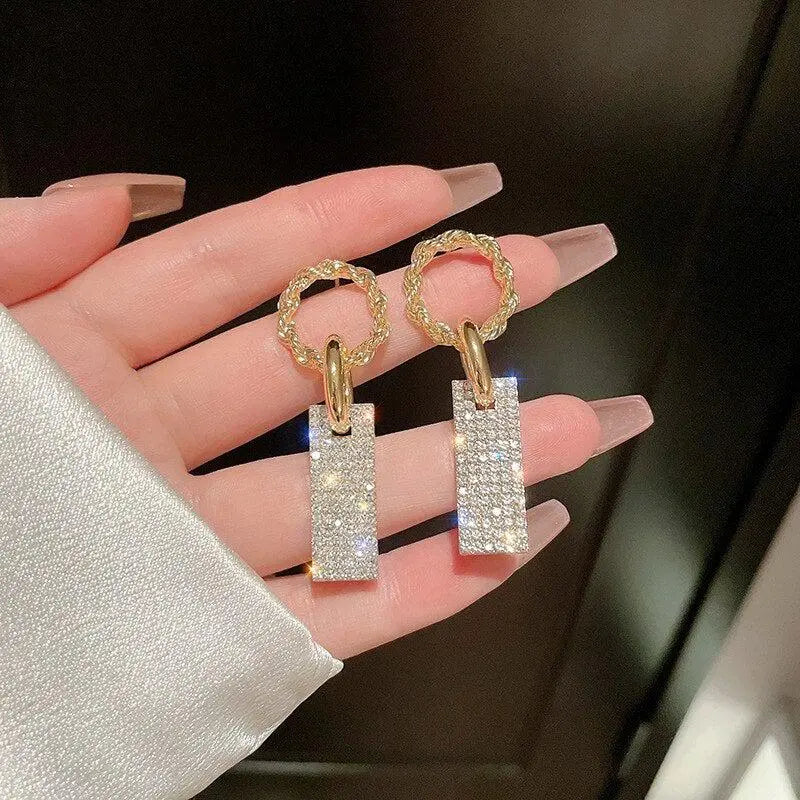 Luxurious earrings with zircons, made of silver and decorated with crystals.