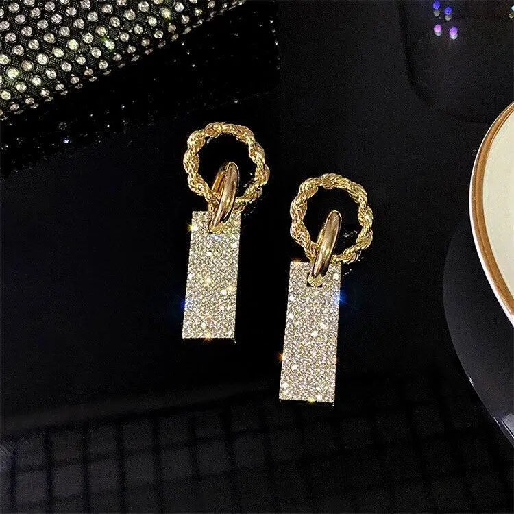Luxurious earrings with zircons, made of silver and decorated with crystals.