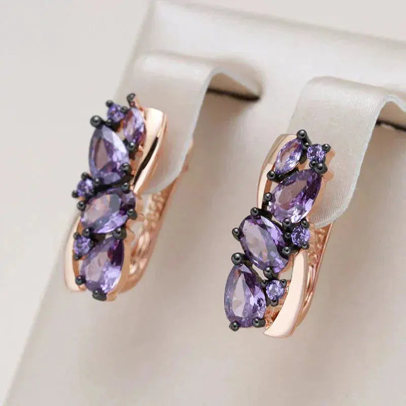 Elegant earrings with small purple crystal in gold color