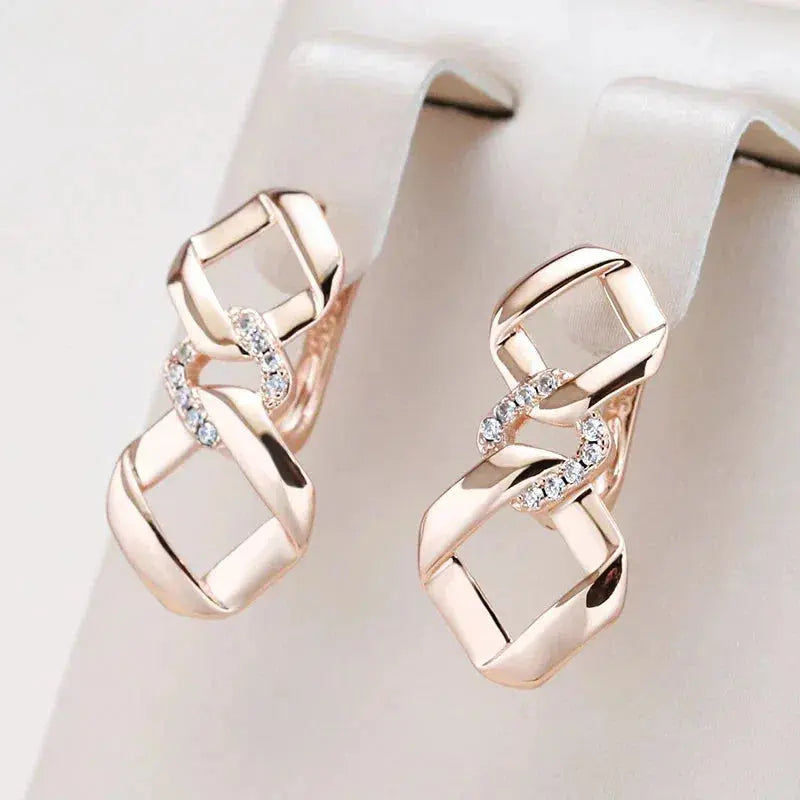 Elegant earrings with zircons in gold color