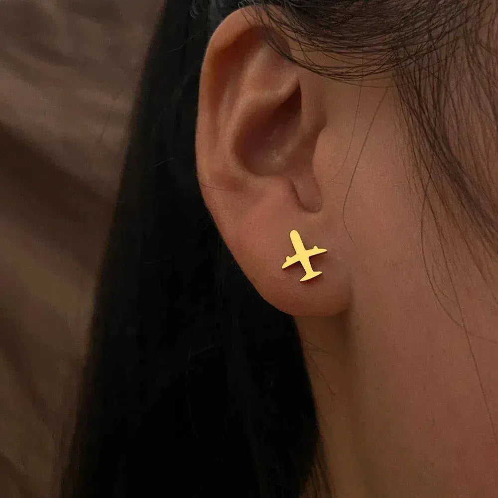 Gold earrings in the shape of an airplane