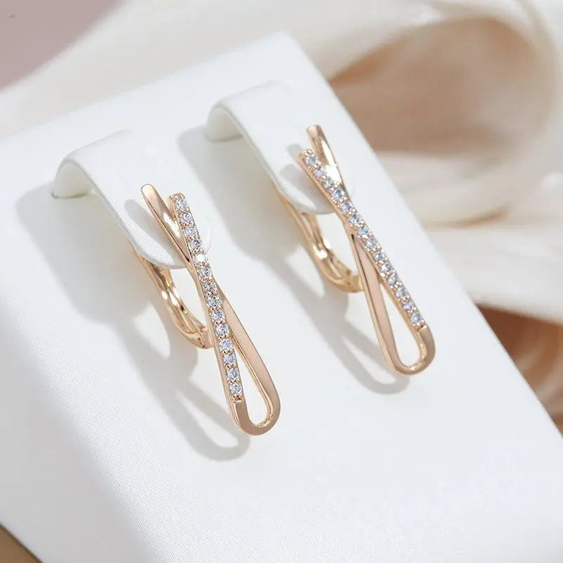 Gold earrings with crossed diamonds