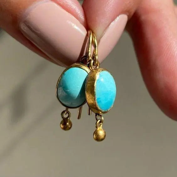 Gold earrings with blue stone