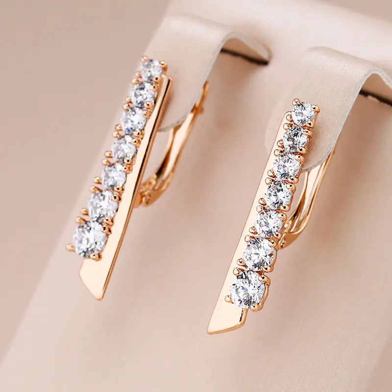 Gold earrings with inlaid zircons