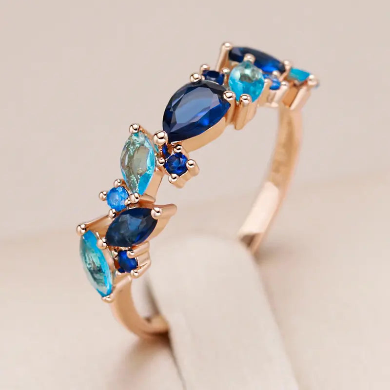 Elegant ring with gold-plated blue crystals