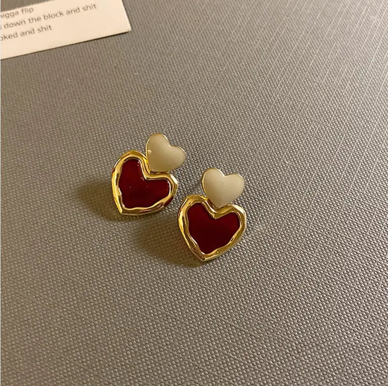 Elegant gold heart earrings in red enamel