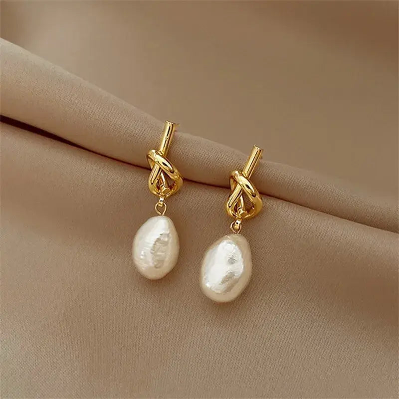 Elegant gold earrings with pearls in baroque style