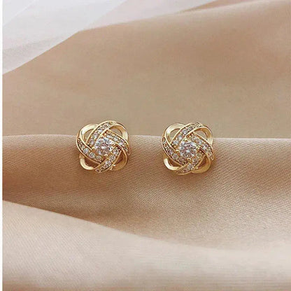 Cross earrings with floral spiral