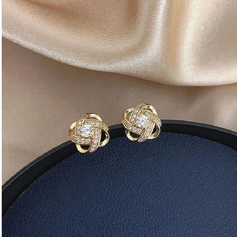 Cross earrings with floral spiral