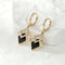 Shiny black earrings in elegant gold