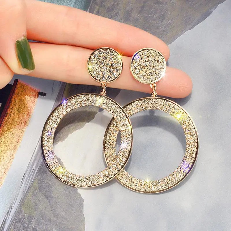 Gold and silver earrings with zircons