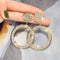 Gold and silver earrings with zircons