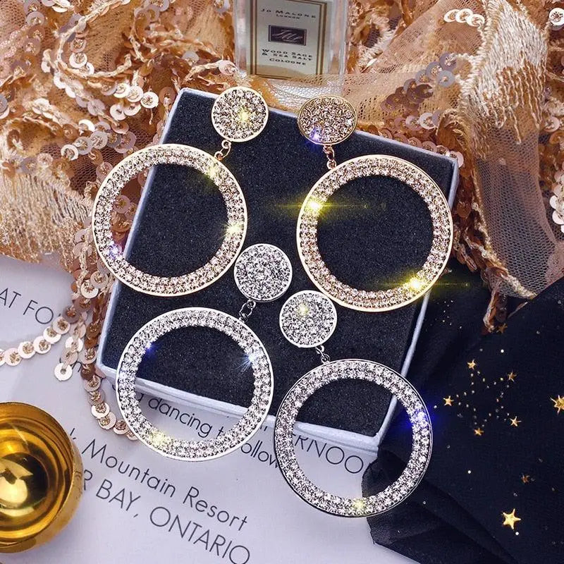 Gold and silver earrings with zircons