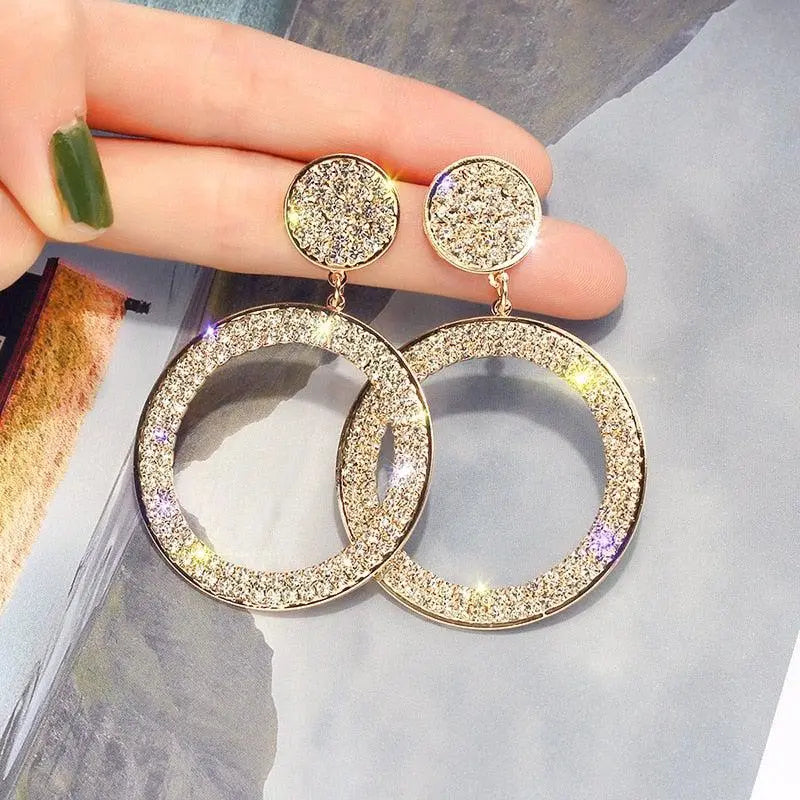 Gold and silver earrings with zircons