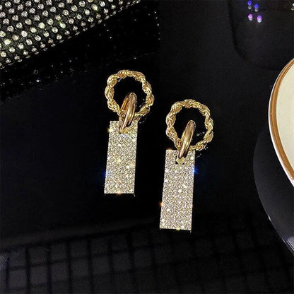 Luxurious earrings with zircons, made of silver and decorated with crystals.