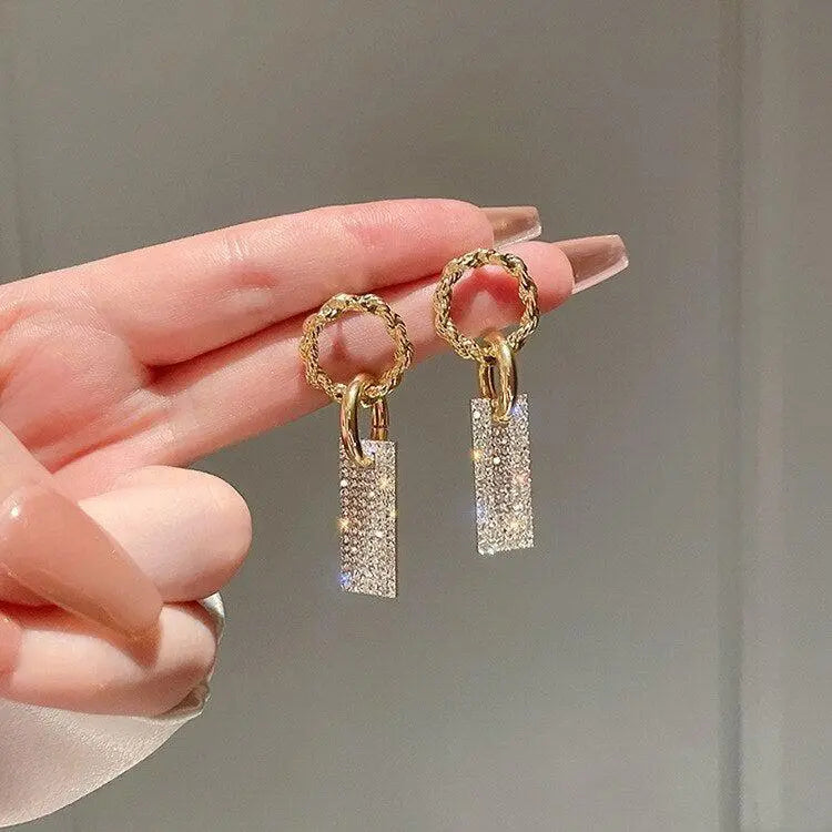 Luxurious earrings with zircons, made of silver and decorated with crystals.