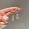 Luxurious earrings with zircons, made of silver and decorated with crystals.