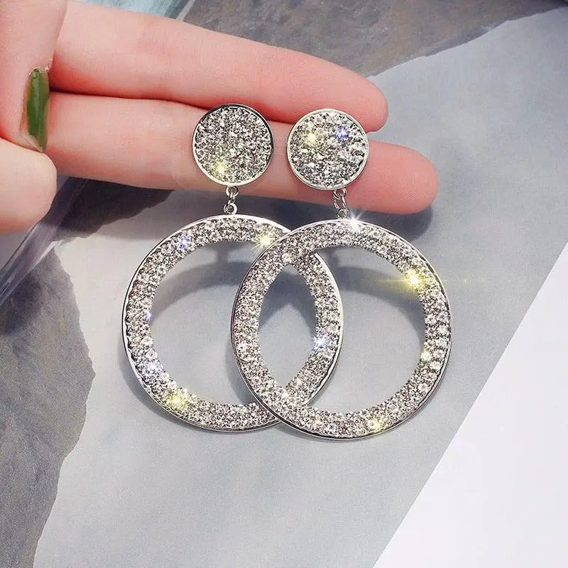 Gold and silver earrings with zircons