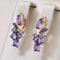 Elegant gold earrings with purple zircons