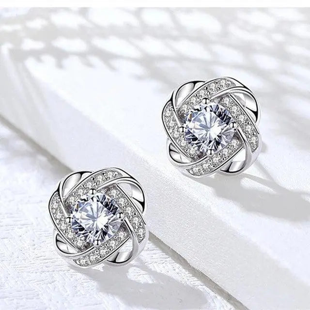 Cross earrings with floral spiral