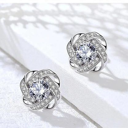 Cross earrings with floral spiral