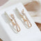 Gold earrings with crossed diamonds