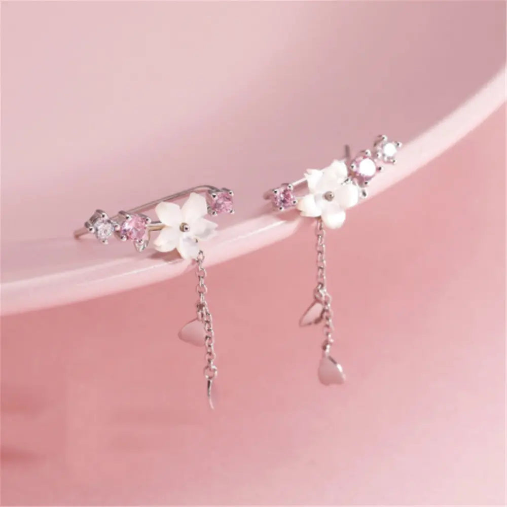 Silver flower-shaped earrings with pink stones