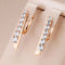 Gold earrings with inlaid zircons