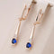 Hanging earrings with blue crystal in gold color