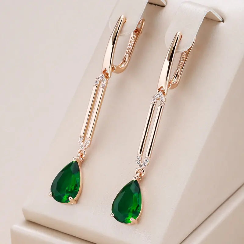 Pendant earrings with green crystals in gold color