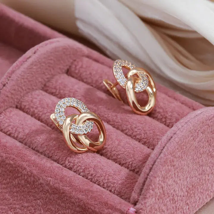 Elegant earrings with zircons in gold color