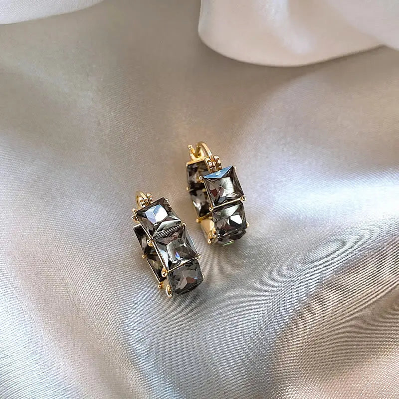 Gold earrings with black zircons