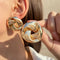 Elegant earrings with a gold bow