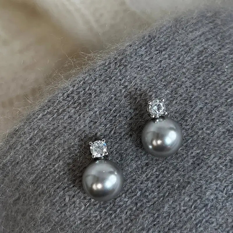 Elegant earrings with black pearls and zircons