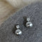 Elegant earrings with black pearls and zircons