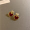 Elegant gold heart earrings in red enamel