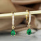 Gold-colored crystal pendant earrings