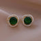 Green earrings with a shiny spiral
