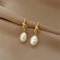 Elegant gold earrings with pearls in baroque style