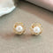 Elegant gold spiral pearl earrings with zircons