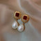 Elegant gold earrings in red with pearls