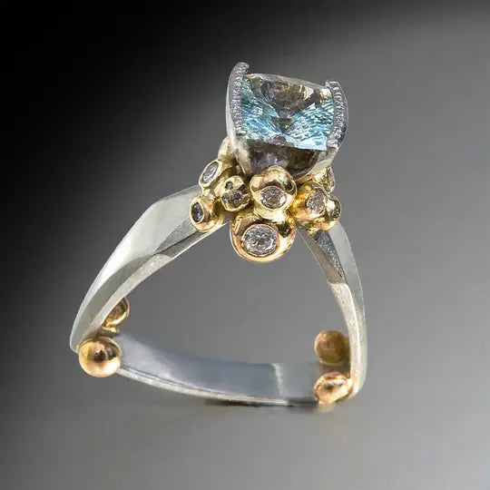 Gold and silver ring with blue zircons in vintage style