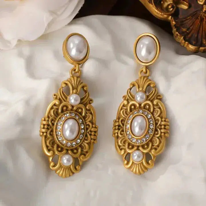 White vintage earrings in gold color